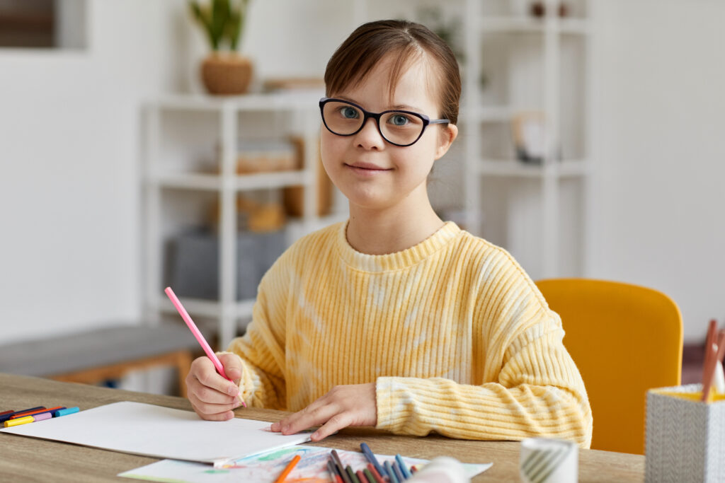 Girl With Down Syndrome Studying At Home