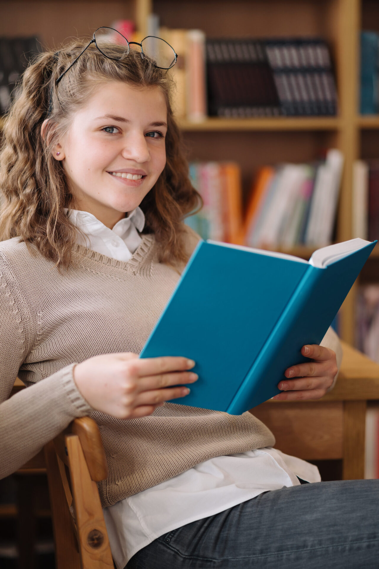 Beautiful Girl Is Studying Reading A Book While Standing On The Floor Among Books In The Bookshop