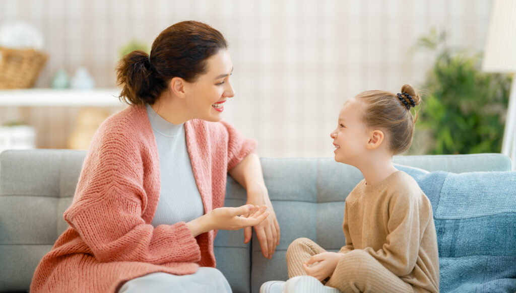 Mom And Her Daughter Smiling And Chatting