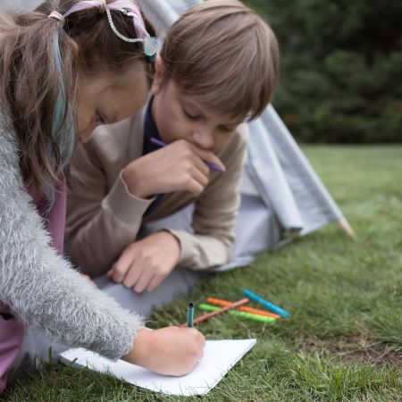 Two kids are playing with stationary in Learning disability evaluation session