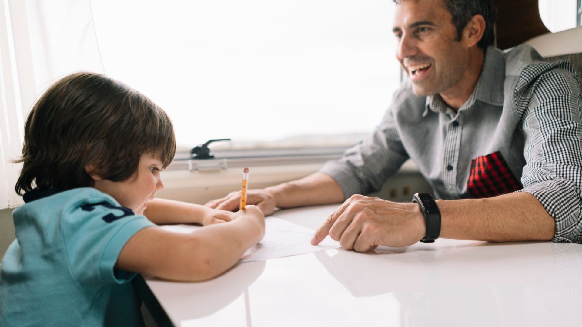 A dyslexic kid sitting with a teacher, highlighting how Lindamood Bell is evidence-based in supporting learning.